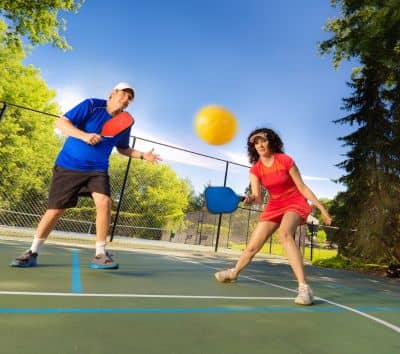 Playing pickleball men & women close look